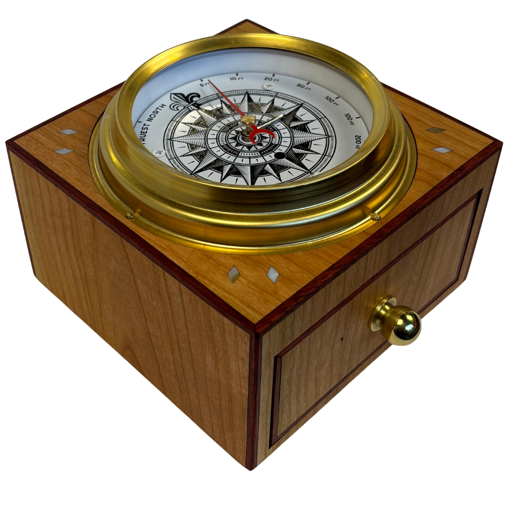 compass on a wooden box with brass accents on a white background